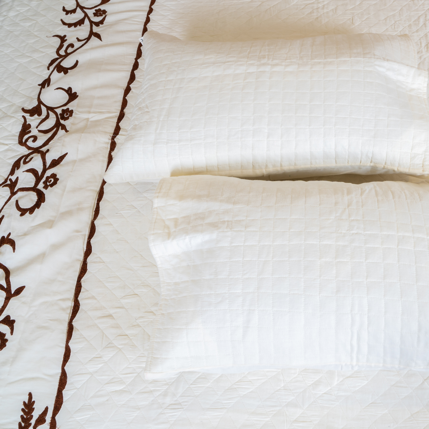 The LuxeLife White Quilted Brown Embroidered Bedcover